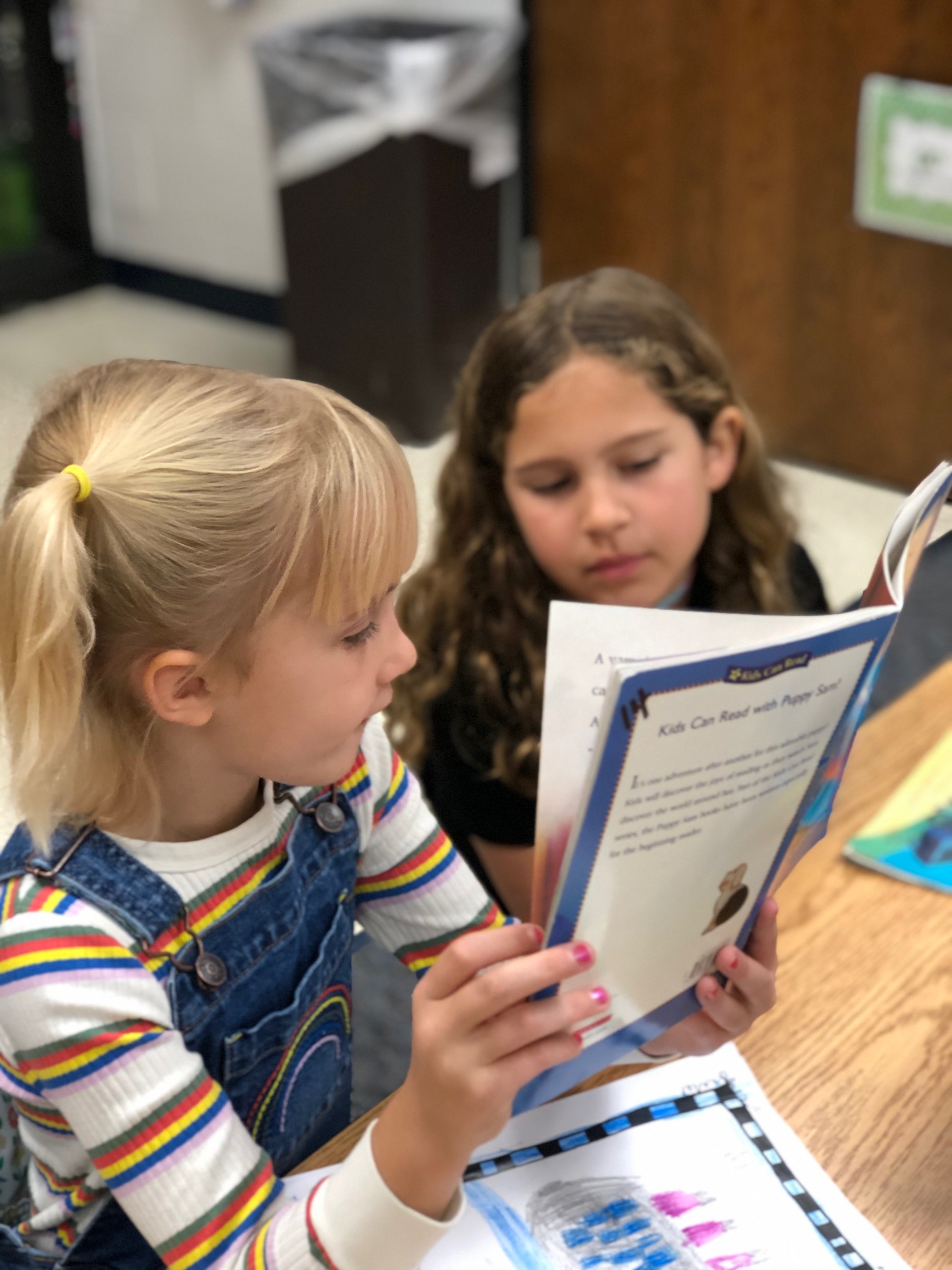 2 students sharing a book